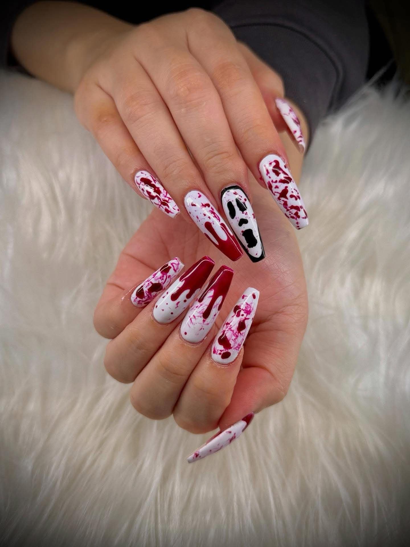 Long coffin nails in white with crimson splatter and a painted ghost face