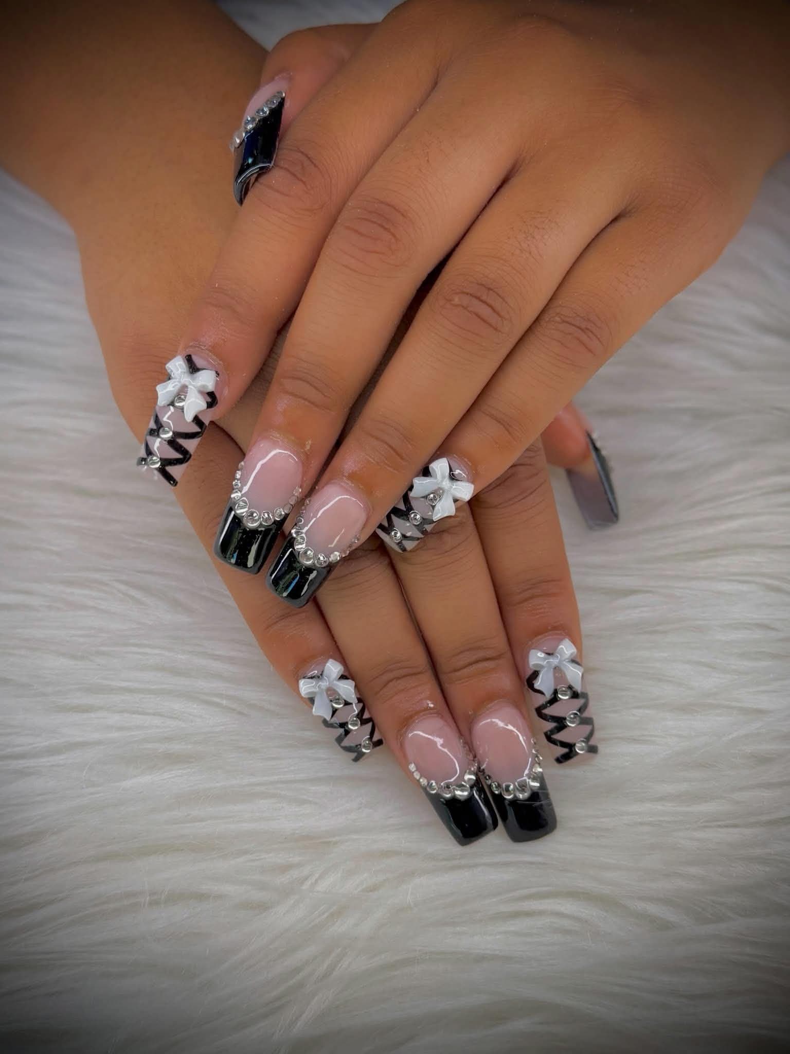 Square nails with glossy black tips, crystal edging and white 3D bows